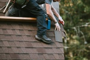 Man laying out material on roof