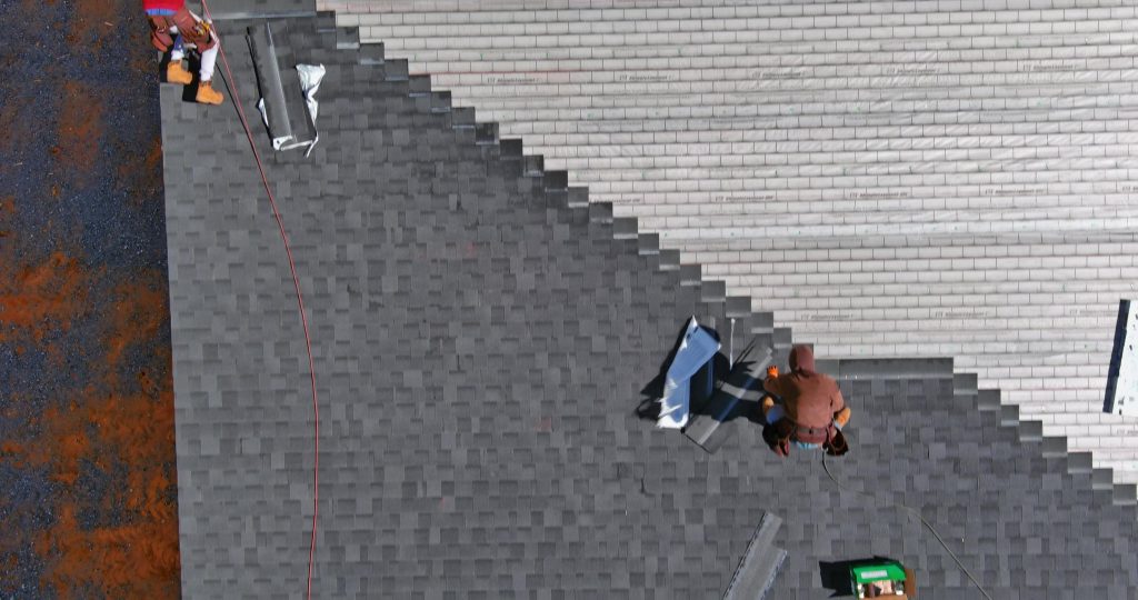 Man carefully working on roof