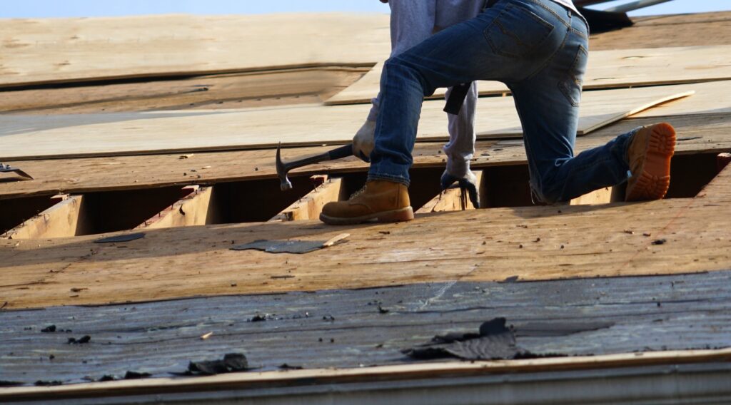 man repairing roof in Bangor Maine